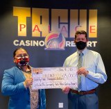 Tachi Palace Casino Resort Marketing Director Rogelio Morales presents $25,000 check to KCAO's Executive Director Jeff Garner.